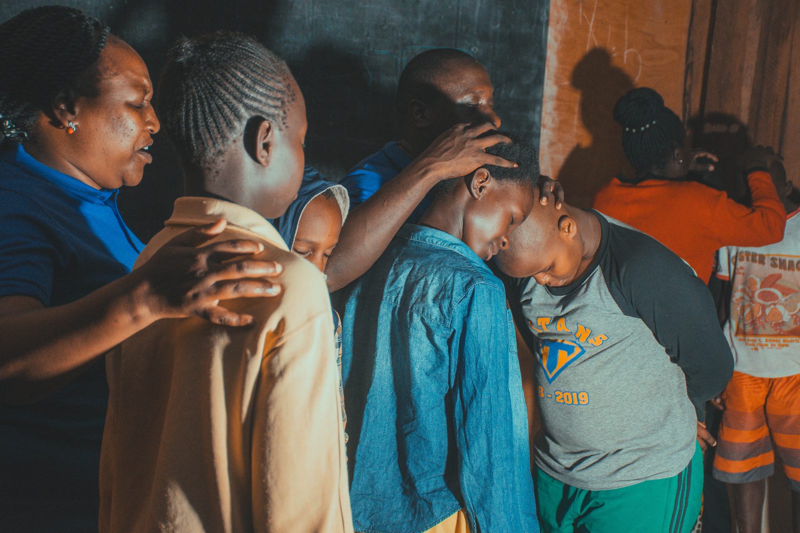 Hearts of Love Africa praying with children in the community